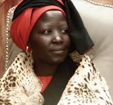 Rain Queen Makobo Modjadji VI wearing a red and black head covering and leopard skin
